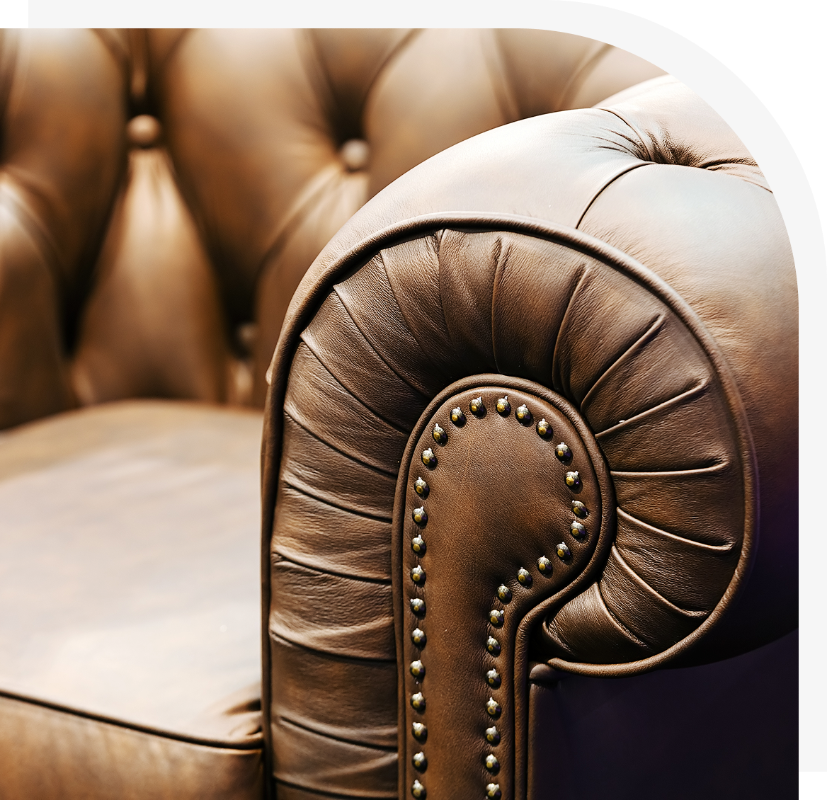 Group 1 Brown leather armchair with studded detailing.