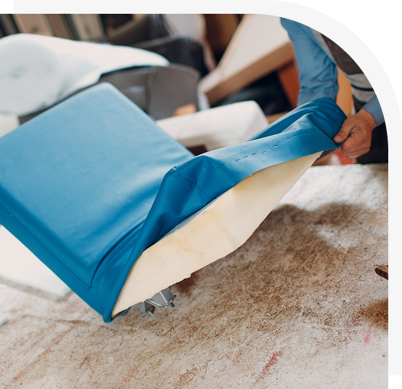 Group 146 Person upholstering chair with blue fabric.